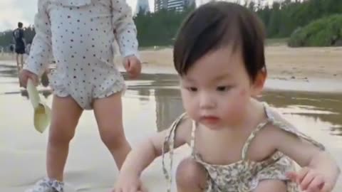 Cute Babies playing on beach