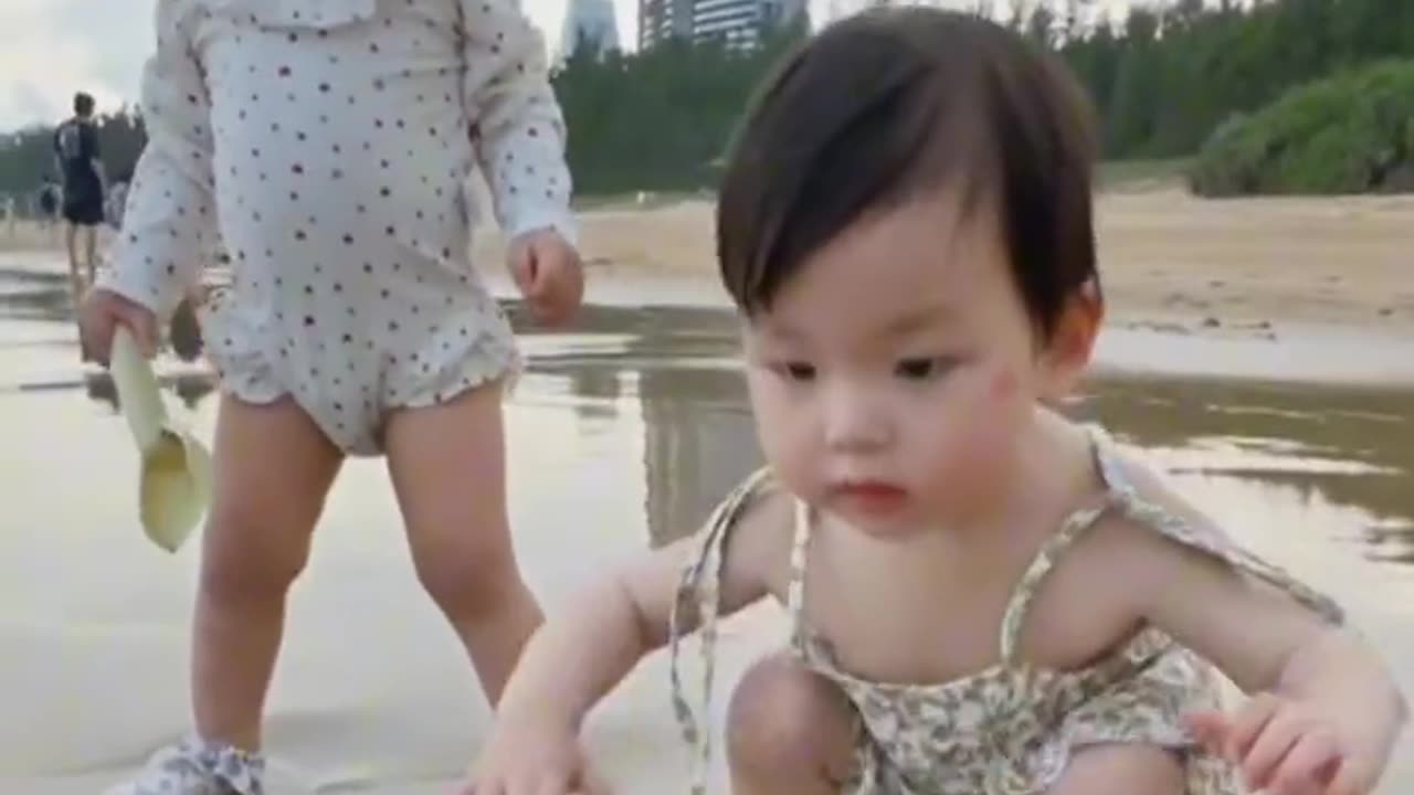 Cute Babies playing on beach