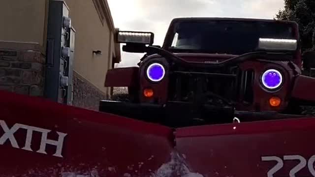 1560# Jeep Wrangler plowing snow with a Boss HTX V Plow