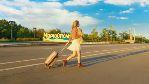 Woman walking with dog in park. Cute little puppy shpitz. Video shooting by handheld gimbal