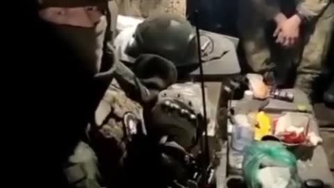 Russian forces feed Ukrainian POWs.