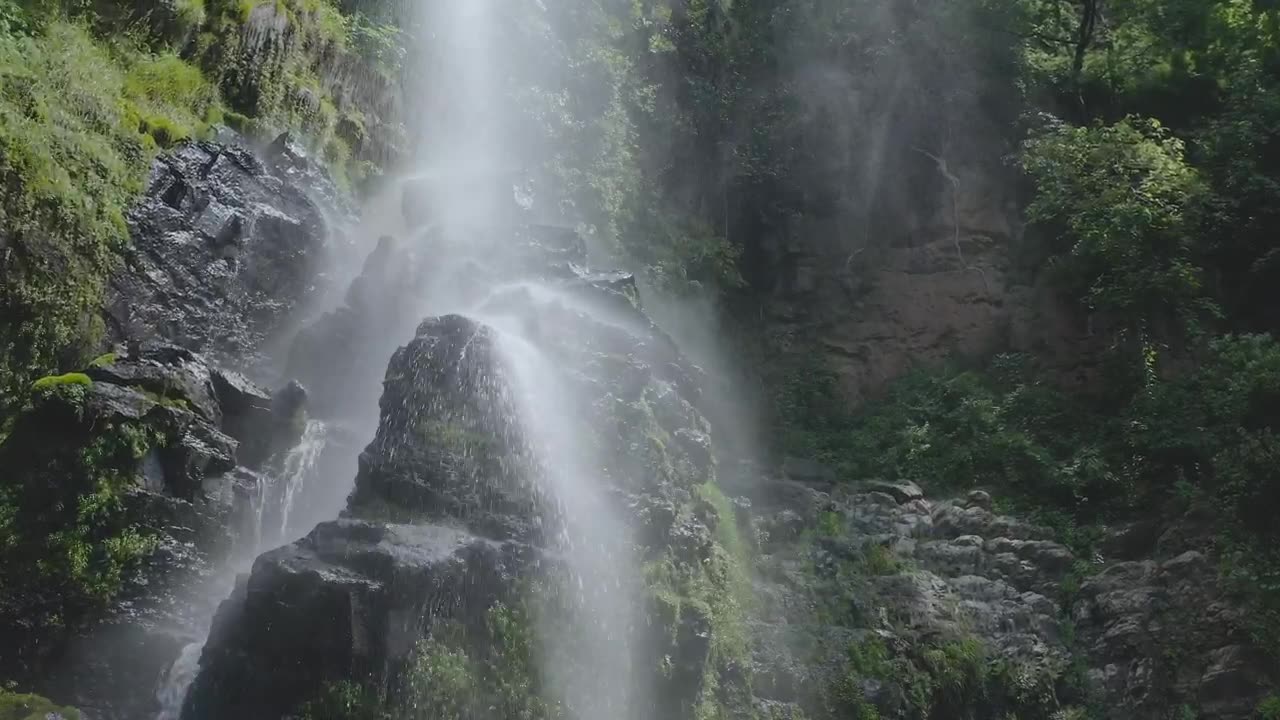 Waterfall with little stones in a temperate forest.