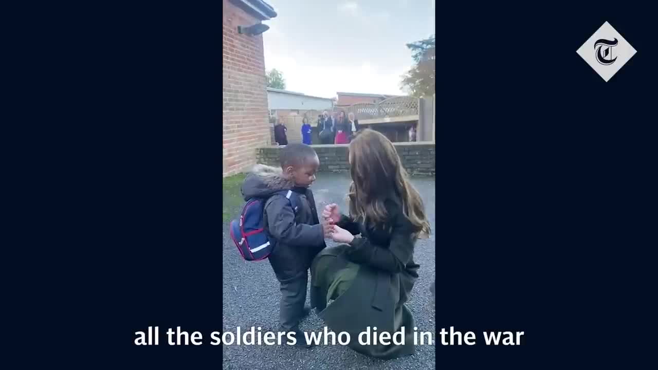 Princess of Wales gives remembrance poppy to young boy during school visit