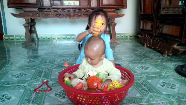 Two kids playing basketball inside toys