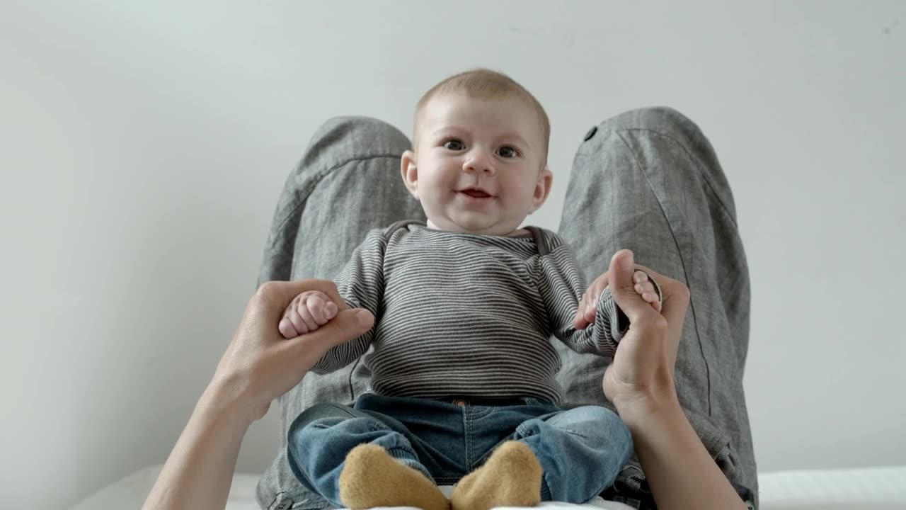 A cute baby is happy playing with mama