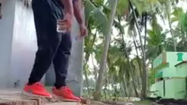 Man Performs Backflip Holding Glass of Water Without Spilling It