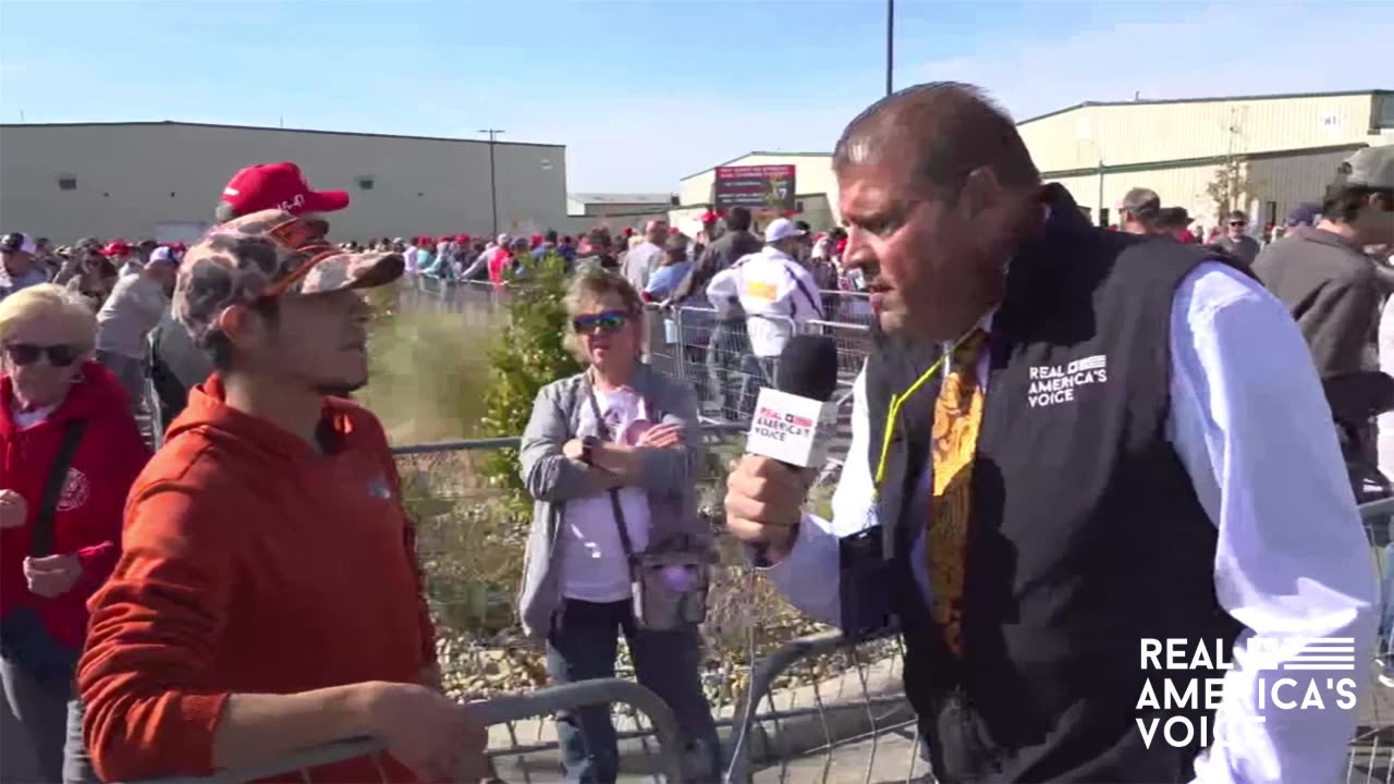 RALLY ATTENDEE IS FRUSTRATED WITH THE IMMIGRATION PROCESS