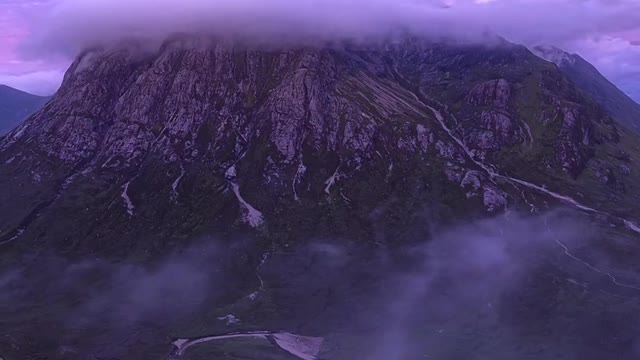 On the top of the mountain in the distance, the clouds are fighting