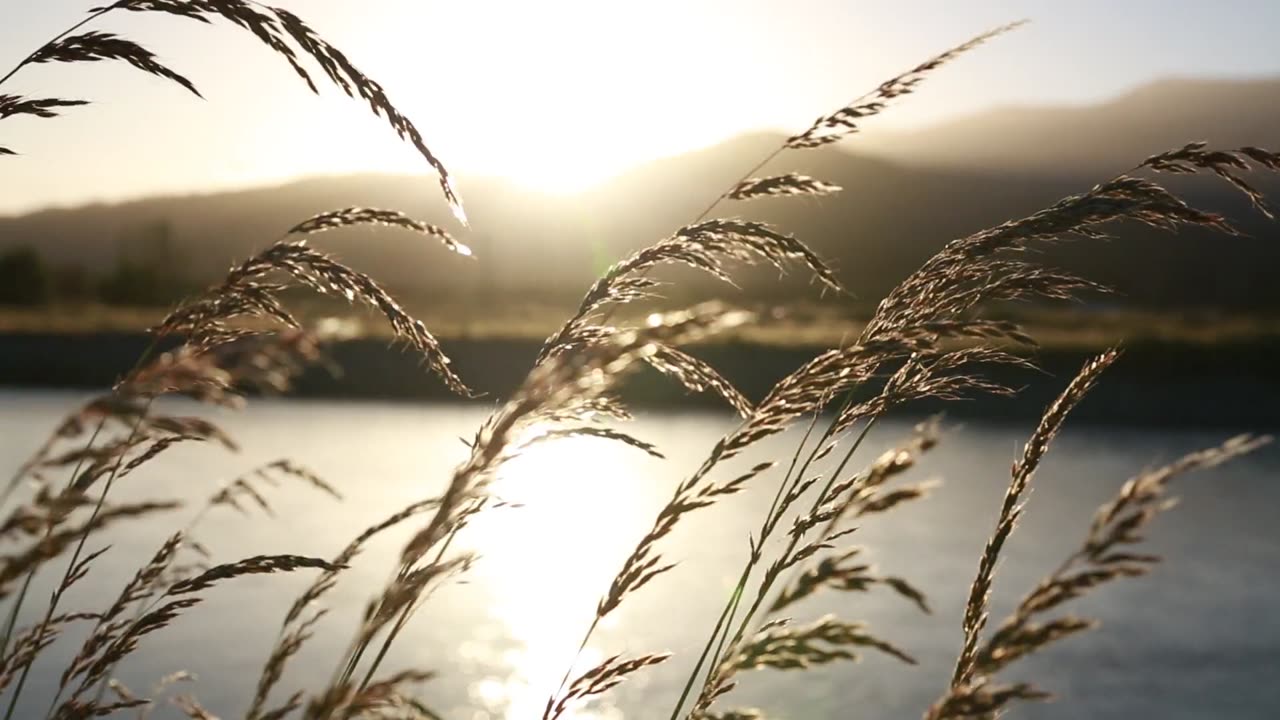 A Sunset Over Mountains, River, and Wind