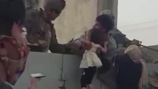 Toddlers and children pulled over wall by U.S. soldiers outsid Kabul airport