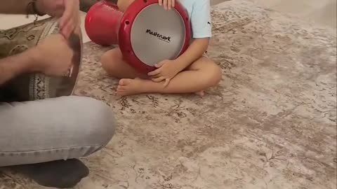 Cute baby band dhol with her father