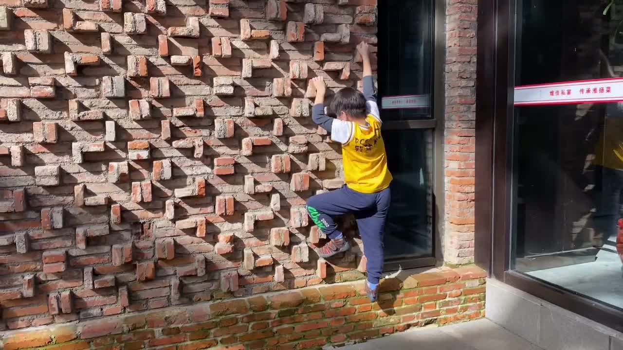 Little guy is a little nervous when he tries to hold stones on the street for the first time