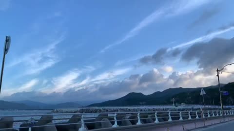 The beautiful sea and sky that you can see in a running car.