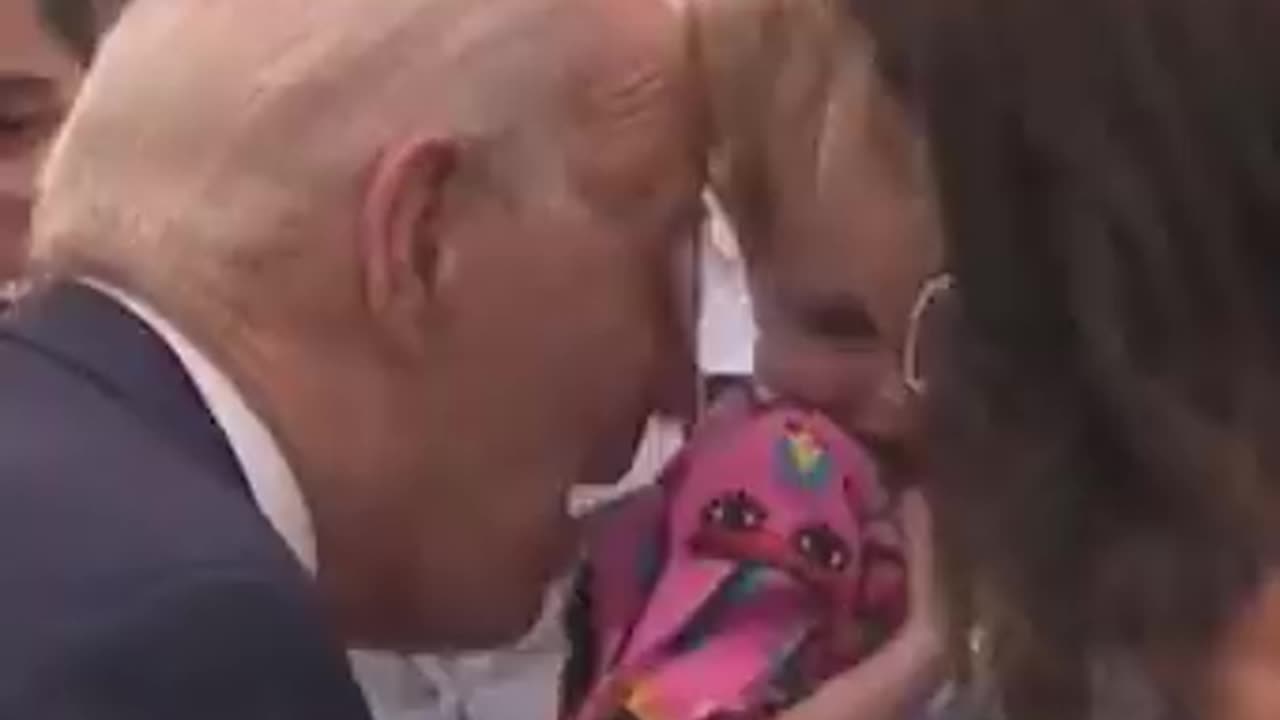 Close up: Biden nibbles on frightened young girl during trip to Finland