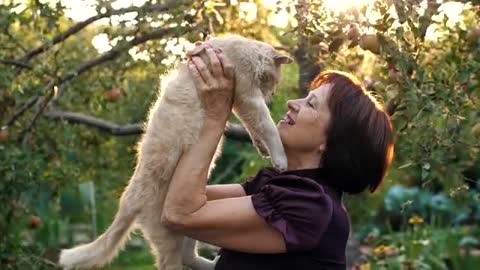 Old woman loving her cat