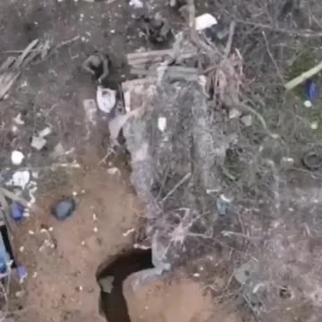 A Ukrainian militant tries to crawl deeper into the trench, but a grenade arrives right on his ass