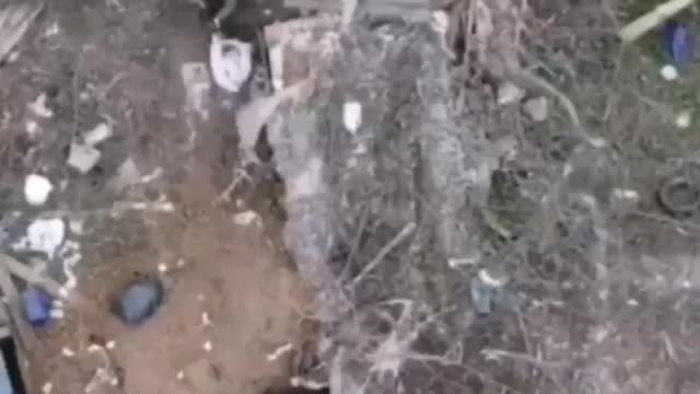 A Ukrainian militant tries to crawl deeper into the trench, but a grenade arrives right on his ass