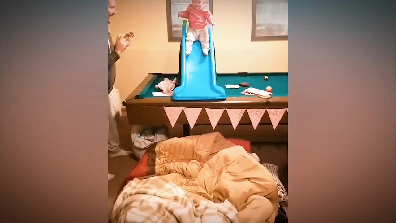 Funny Babies playing slide.