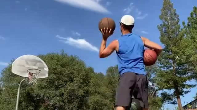 Man Makes Basketballs Shots Relentlessly While Balancing on Balance Board