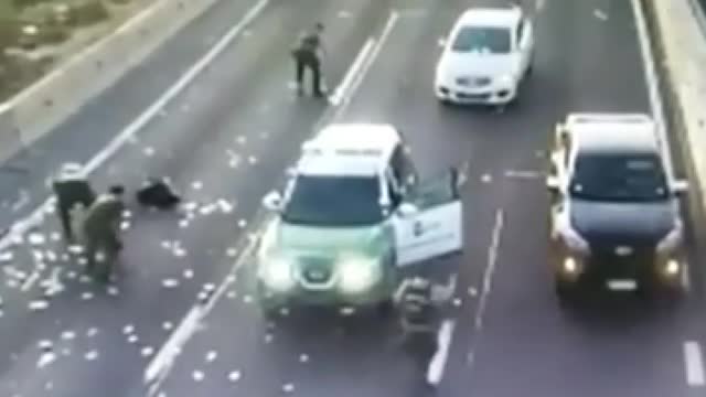 A shop burglary ended in a car chase and money being showered onto a highway