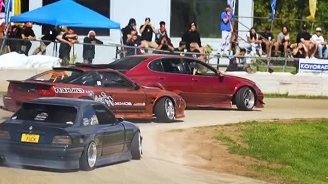 Slow motion footage of cars racing in a velodrome