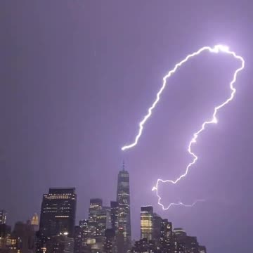 Massive bolt of lightning strikes One World Trade in sudden storm tonight in NY April 1, 2023