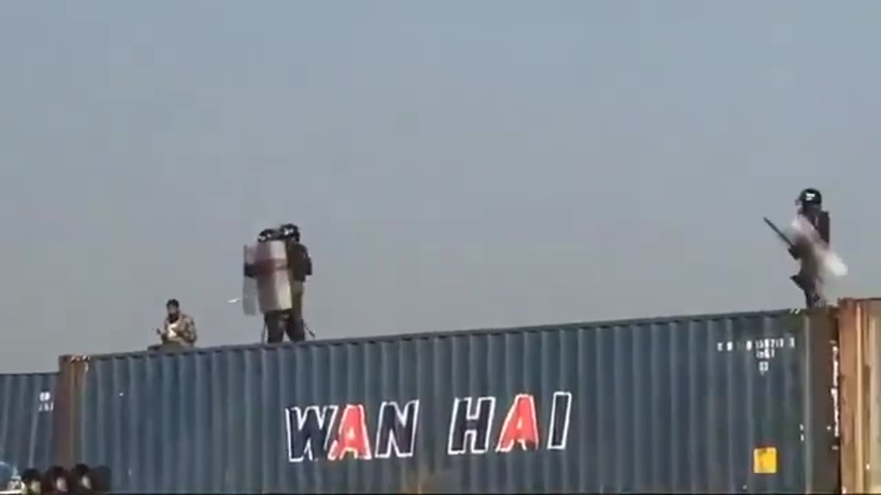 Protester prays to Allah on a container at a protest and Pakistani police throw it