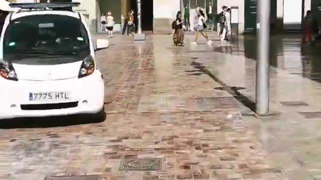 Spanish police car woman driving MÁLAGA central square, Spain. Plaza Constitución 29 June 2022