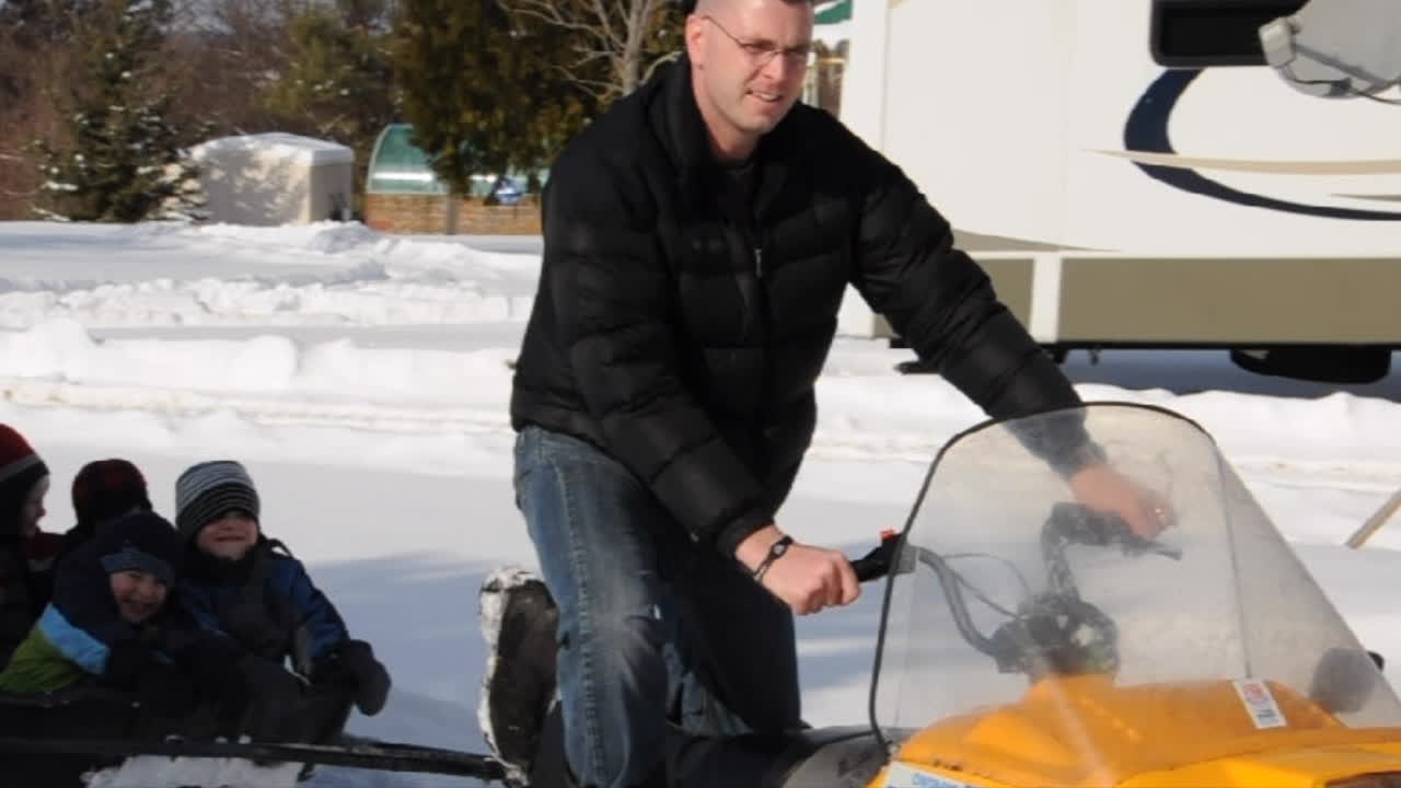 Canadian birthday party snowmobile ride with big smiles!