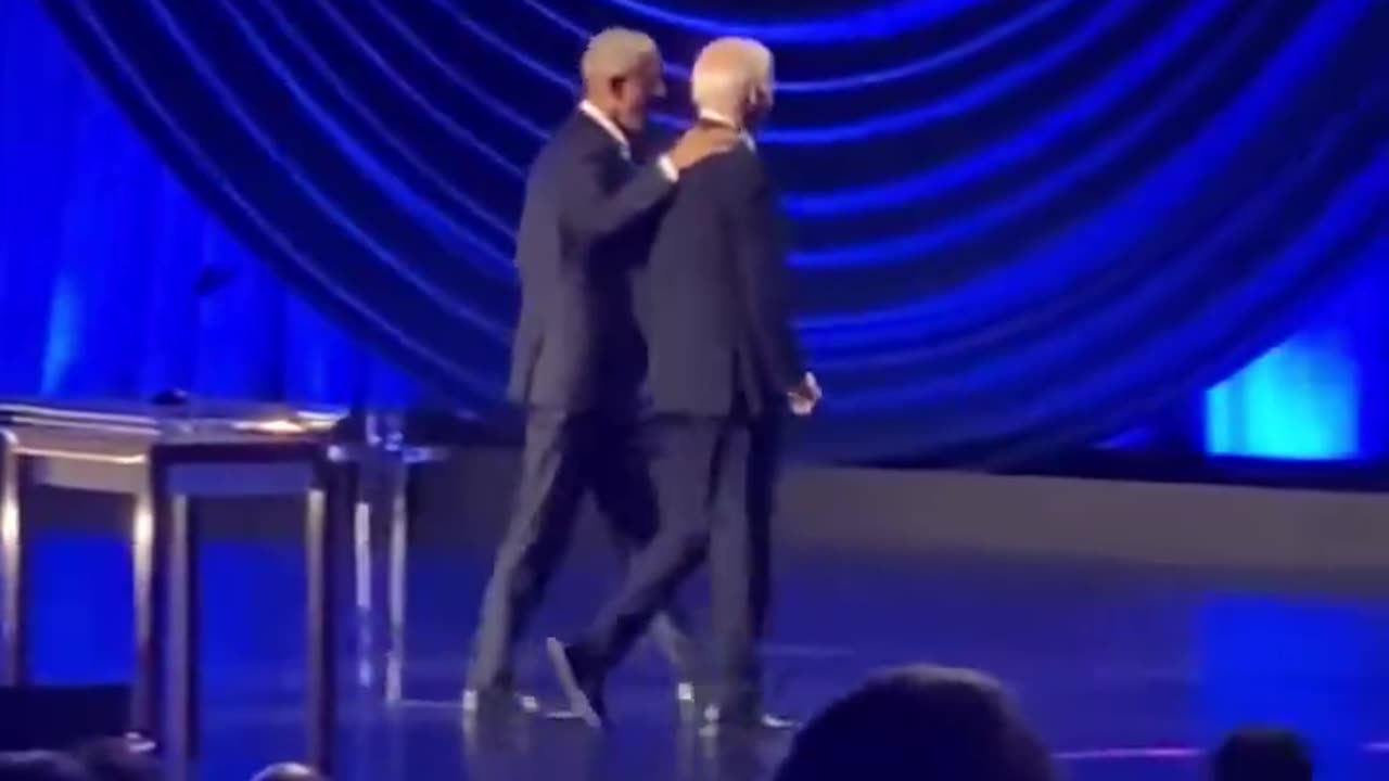 Left-wingers say the video does *not* show Biden freezing up and being led off stage by Obama