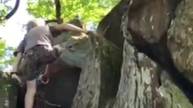 Kid Climbs Huge Rock Faces and Reaches Top of Rocky Terrain