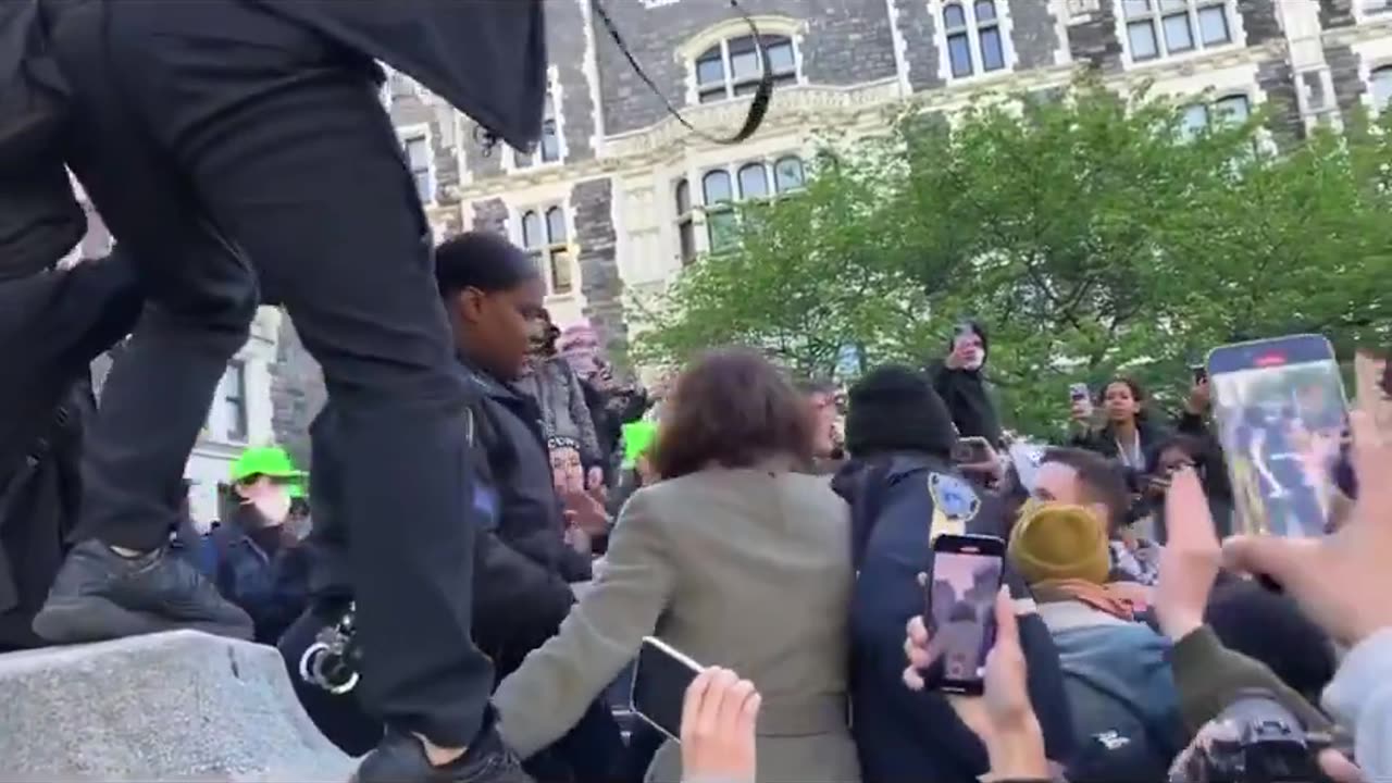 CUNY students and faculty standing together to push the police back