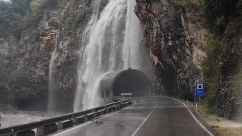 Heavy Rain Creates a Waterfall Over Road