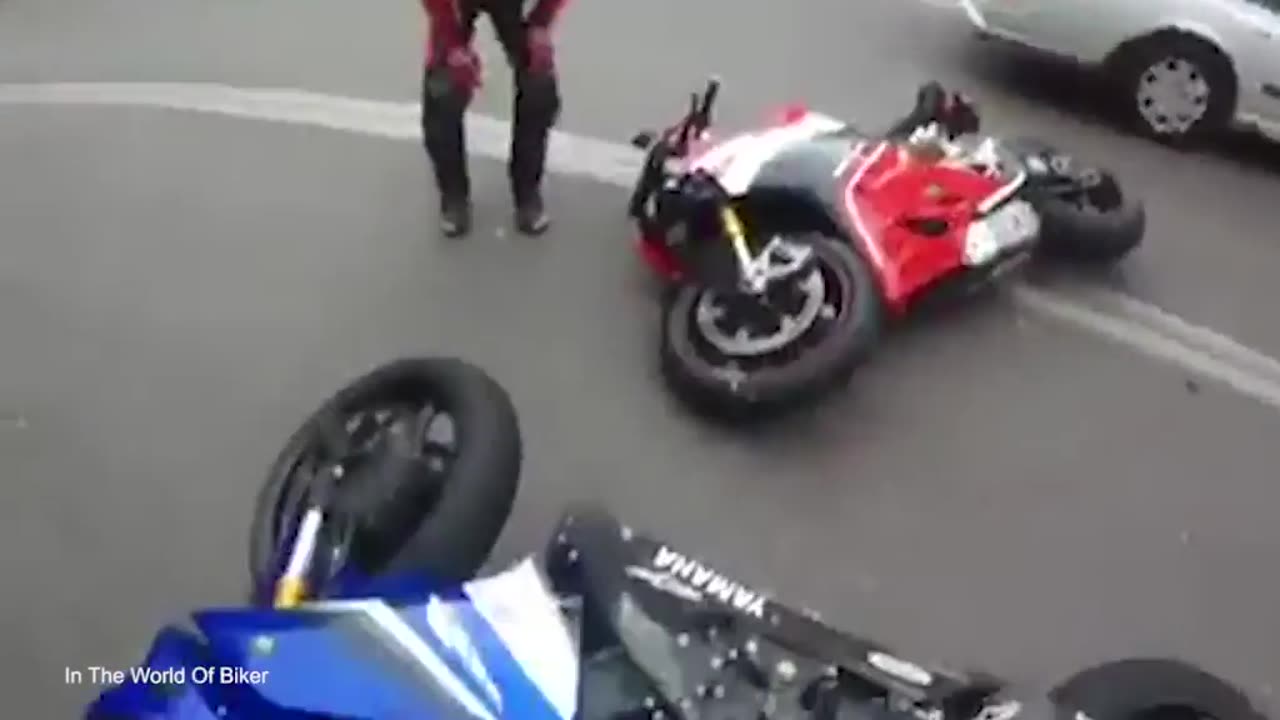 Horrifying moment a motorcyclist hits an oncoming car