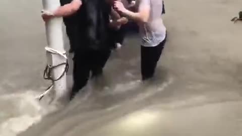 Central China floods- woman being pulled out and save