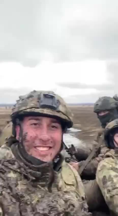 Dirty, tired, up to their necks in mud, but smiling.