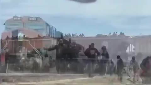 Footage of Some Muy Feliz Immigrants Crossing the Border into the US by Riding on Top of Train Cars