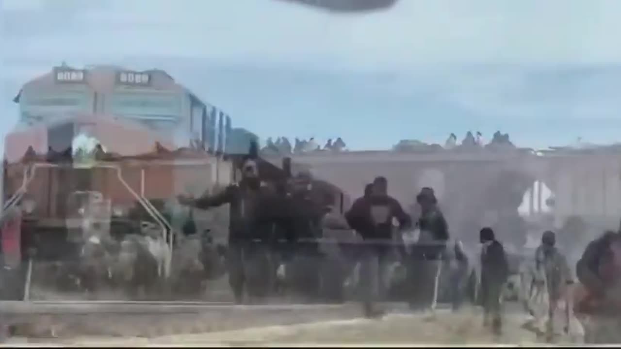 Footage of Some Muy Feliz Immigrants Crossing the Border into the US by Riding on Top of Train Cars