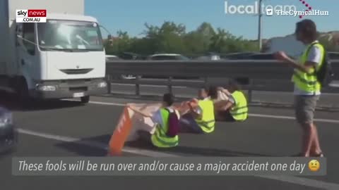 Furious drivers physically drag activists off a busy highway