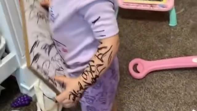 Little Girl Uses Marker And Scribbles On Herself And Things Around Her