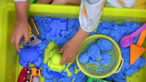 Child's Hand Playing Toy Sand at Home