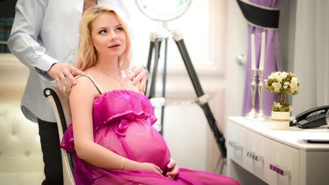 Pregnant woman receives affection from her husband