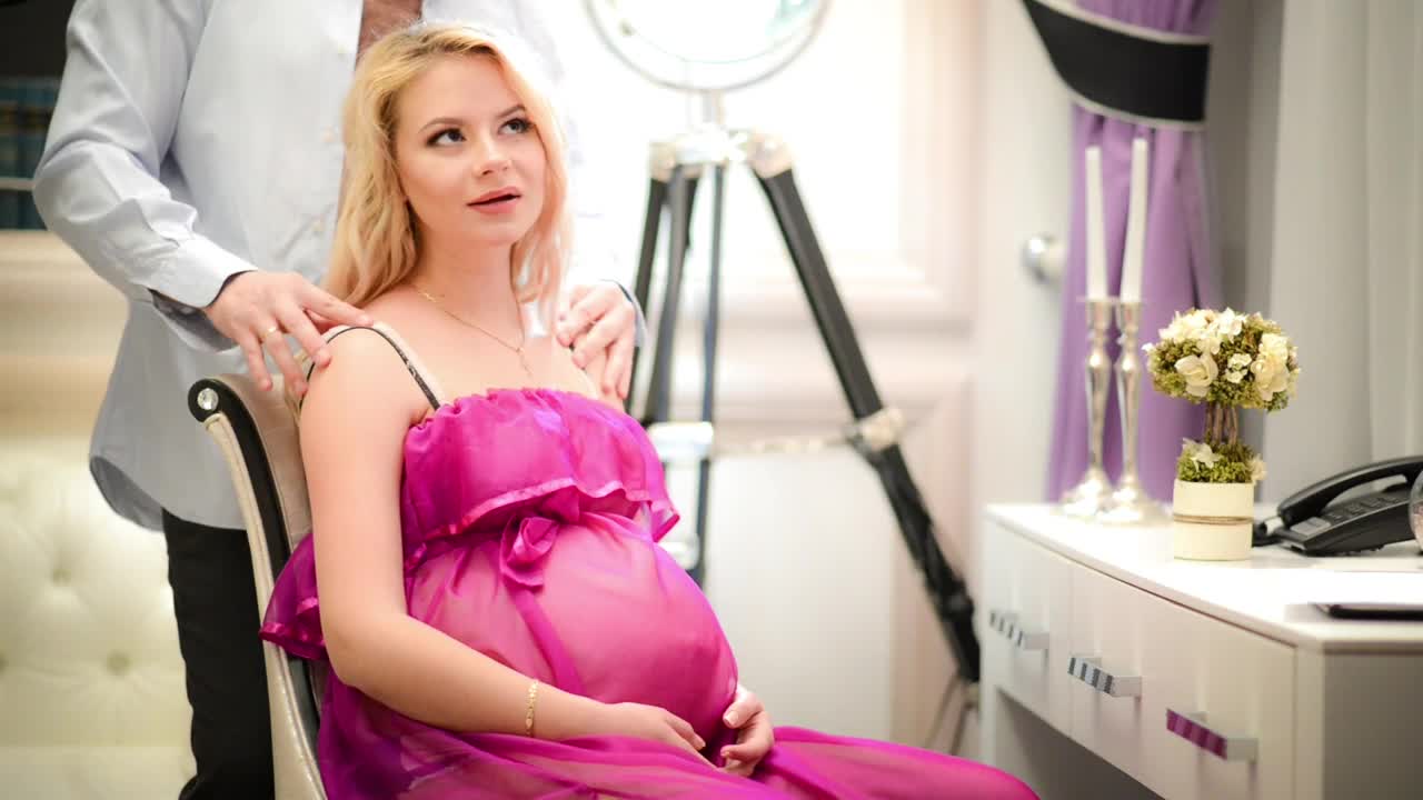 Pregnant woman receives affection from her husband