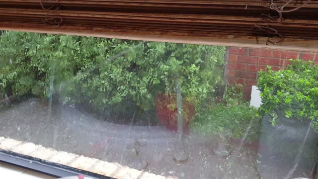 Sudden Hard Hail Storm Outside of Window.