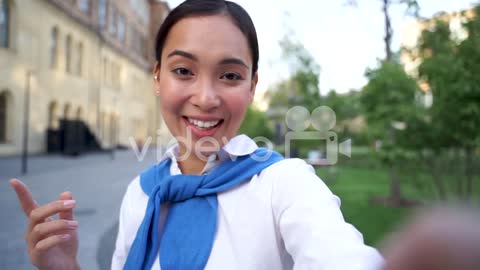 Cheerful Woman Talking To Camera, Having A Video Call Outdoors