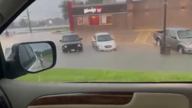 Cars in Parking Spot Get Immersed in Water After Streets Flood During Thunderstorm
