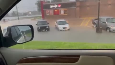 Cars in Parking Spot Get Immersed in Water After Streets Flood During Thunderstorm