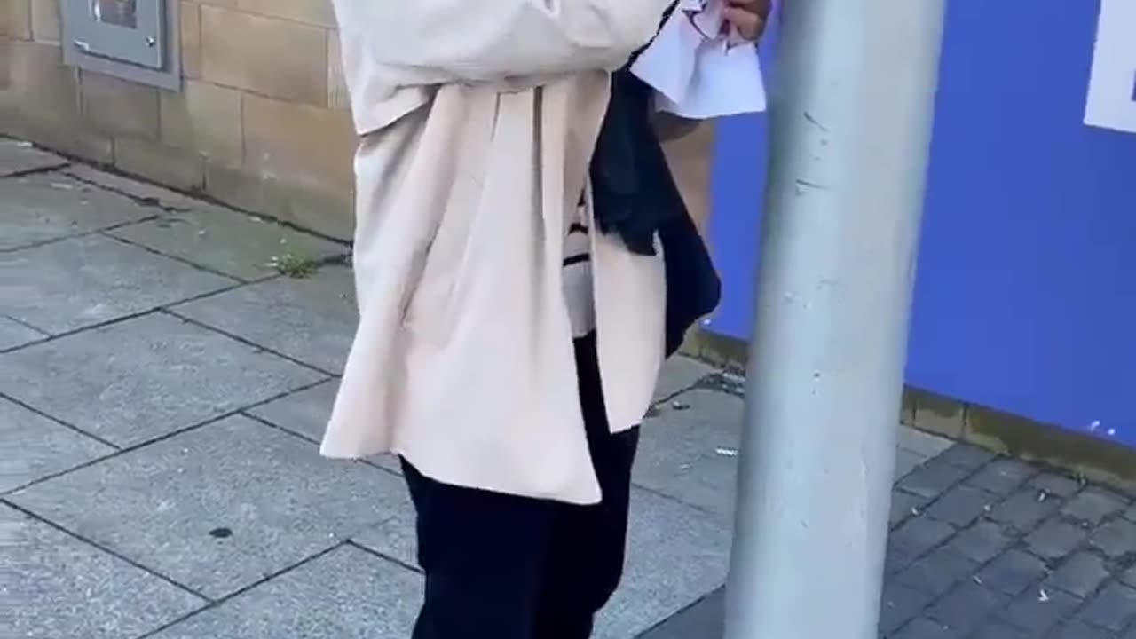 She made sure to cover her face before removing the poster...