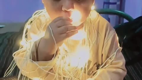Baby playing with electric light