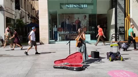 Girl playing guitar - street music